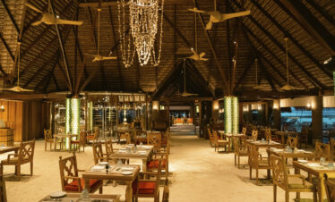 Elegant indoor dining area with a rustic design at Constance Moofushi