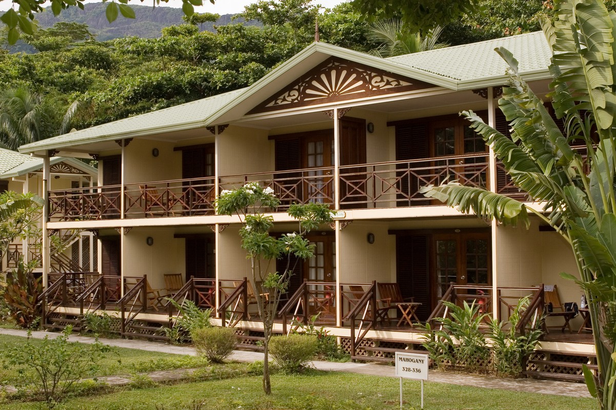 Exterior view of accommodations surrounded by greenery at Berjaya Beau Vallon