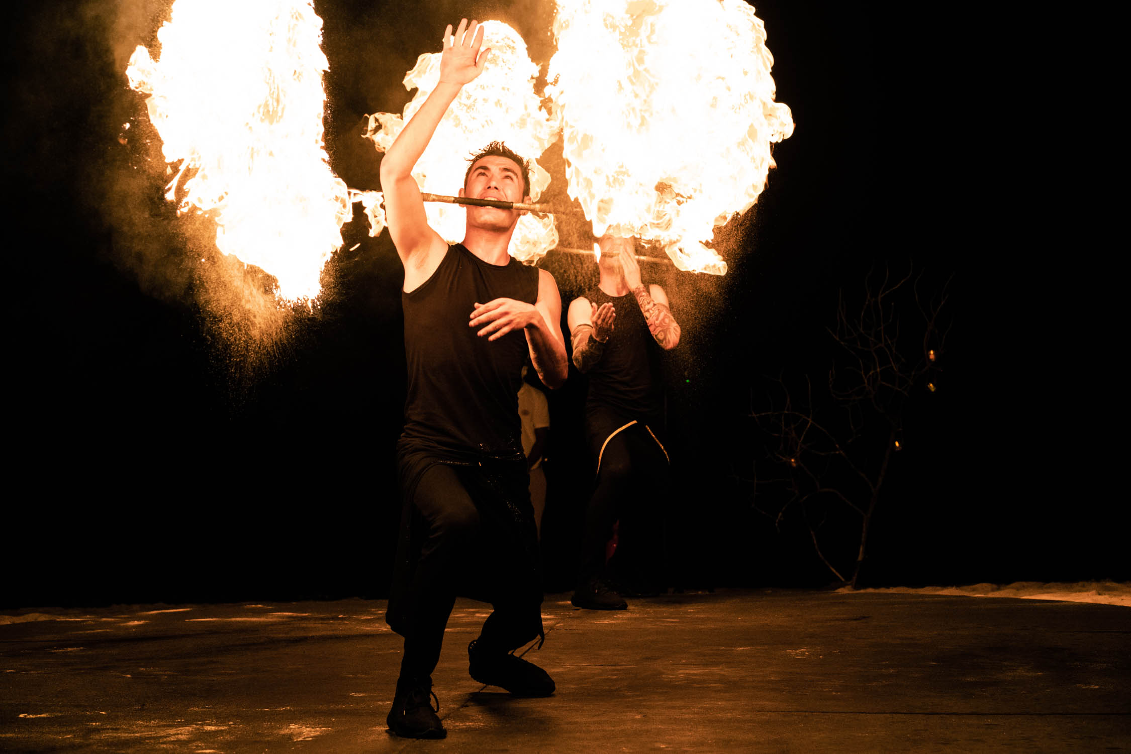 Fire performance at Ayada Maldives showcasing skilled performers under a dark sky