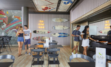 Guests enjoying a meal in a modern dining area at Riu Atoll