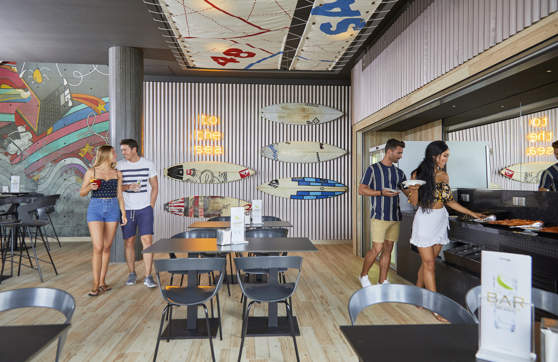 Guests enjoying a meal in a modern dining area at Riu Atoll