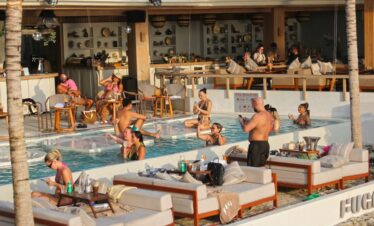 Guests enjoying the pool and lounging area at Diamond Cliff Resort on a sunny day