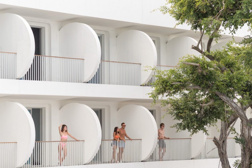 Guests relaxing on their balconies at Avani Chaweng Samui with circular architectural designs