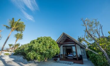 Heritance Aarah beachfront villa surrounded by lush greenery and palm trees