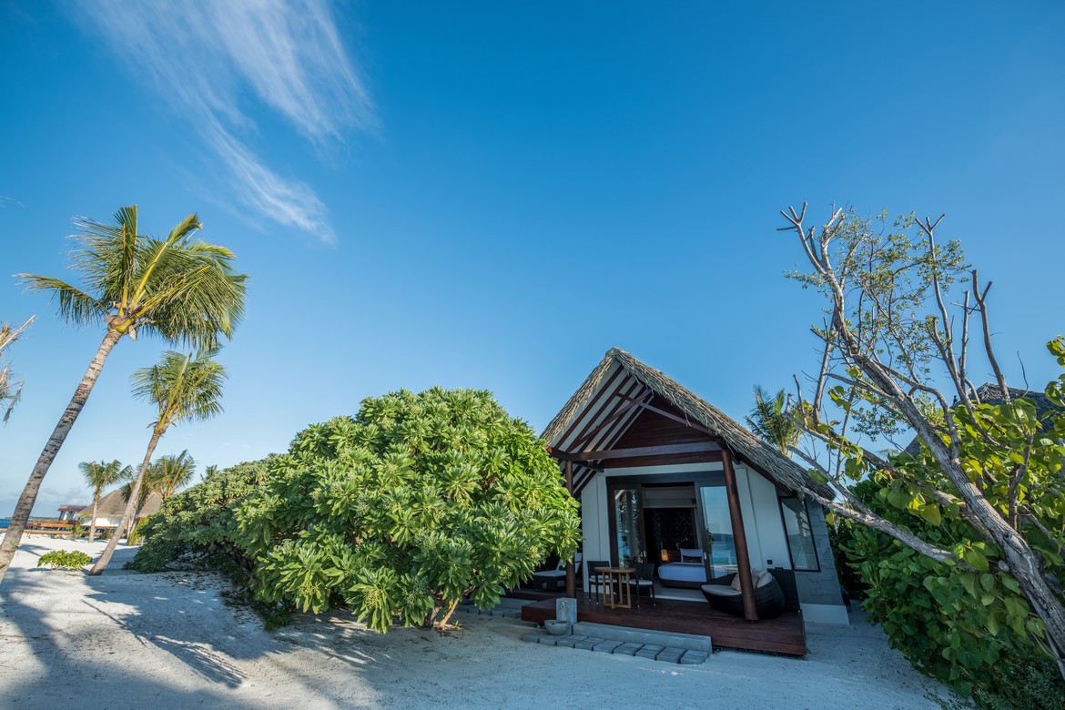 Heritance Aarah beachfront villa surrounded by lush greenery and palm trees