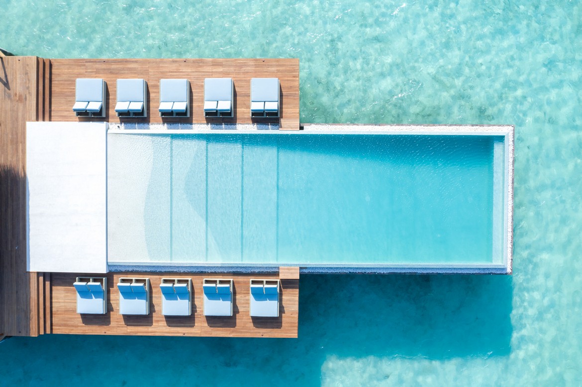 Heritance Aarah luxurious overwater villas connected by wooden walkways above clear blue ocean