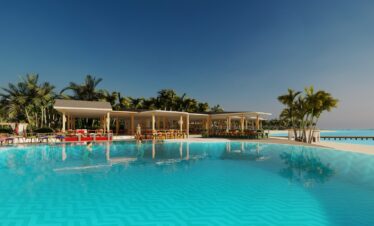 Infinity pool at Joy Island with a backdrop of palm trees