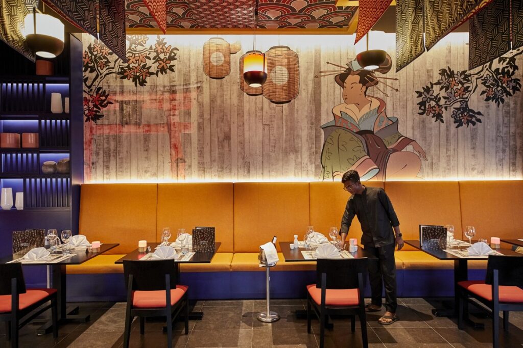 Japanese-themed dining area with artistic wall mural at Riu Palace