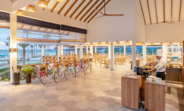 Joy Island restaurant interior with chef preparing a meal