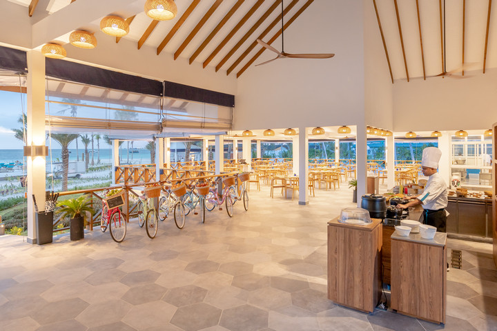 Joy Island restaurant interior with chef preparing a meal