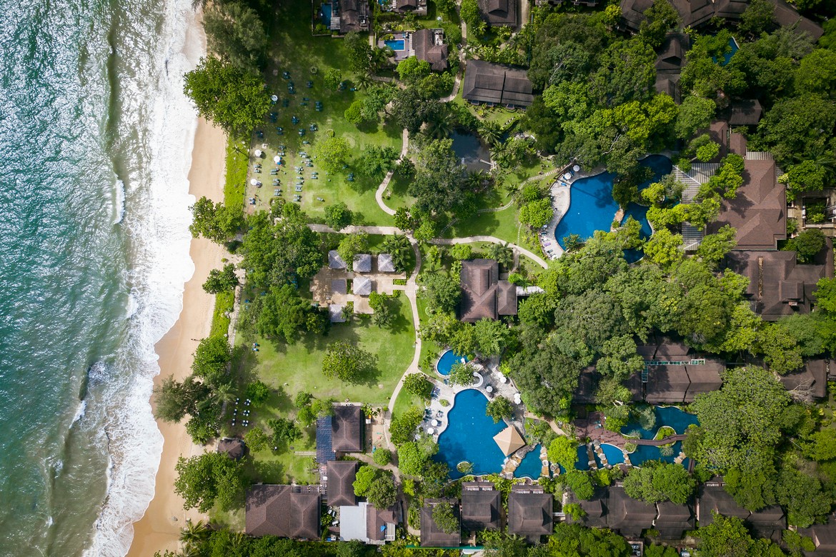 Khao Lak Merlin aerial view showcasing the resorts pools and beachfront area