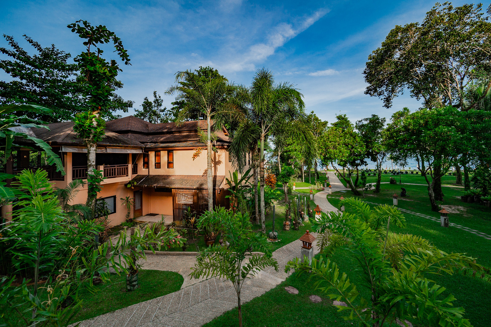Khao Lak Merlin resort building surrounded by lush greenery and tropical trees
