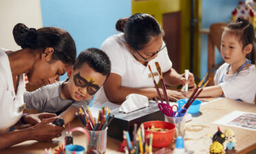 Kids club activity at Sun Siyam Iru Fushi with children enjoying arts and crafts with attentive staff