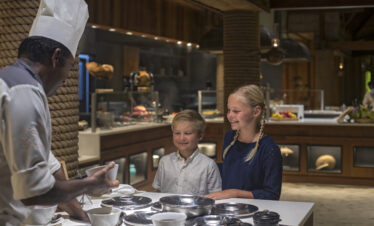 Kids interacting with chef during a cooking session at Constance Moofushi