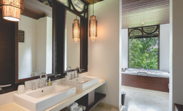 Luxurious bathroom with twin sinks and a soaking tub at The Vijitt Resort