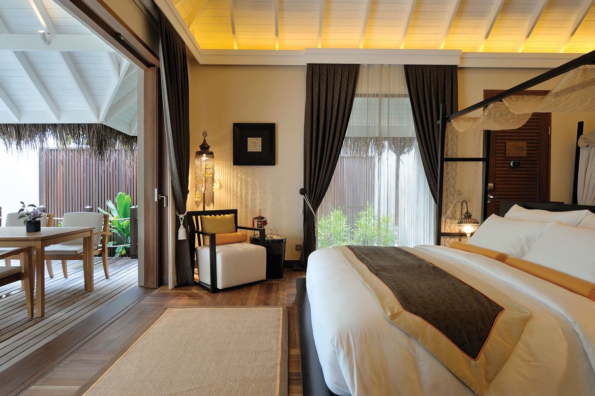 Luxurious bedroom interior at Ayada Maldives with outdoor access to a private deck