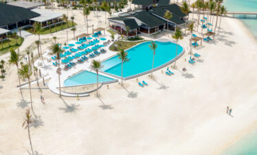 Luxurious poolside view of Joy Island with sun loungers