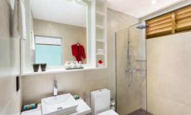 Modern bathroom at Meeru Island Resort featuring a walk in shower and minimalist design with tropical accents