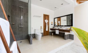 Modern bathroom at Vilamendhoo with a walk In shower double sinks and minimalist design