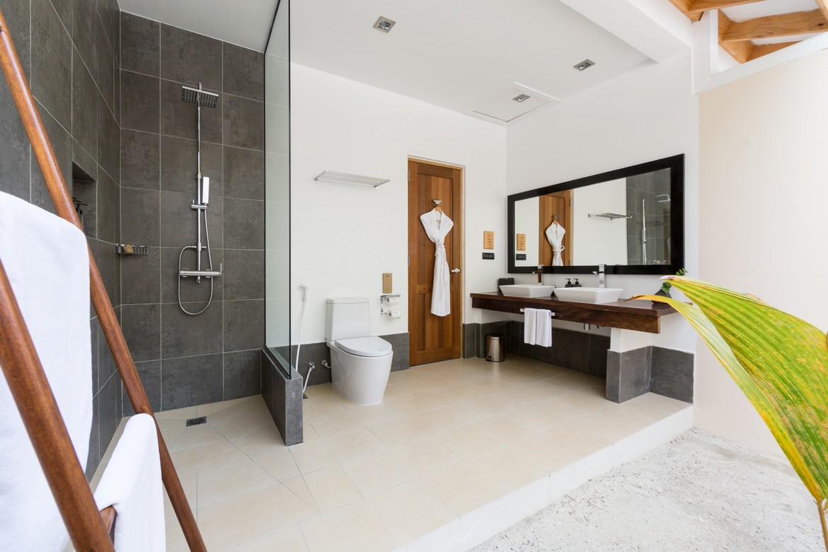 Modern bathroom at Vilamendhoo with a walk In shower double sinks and minimalist design