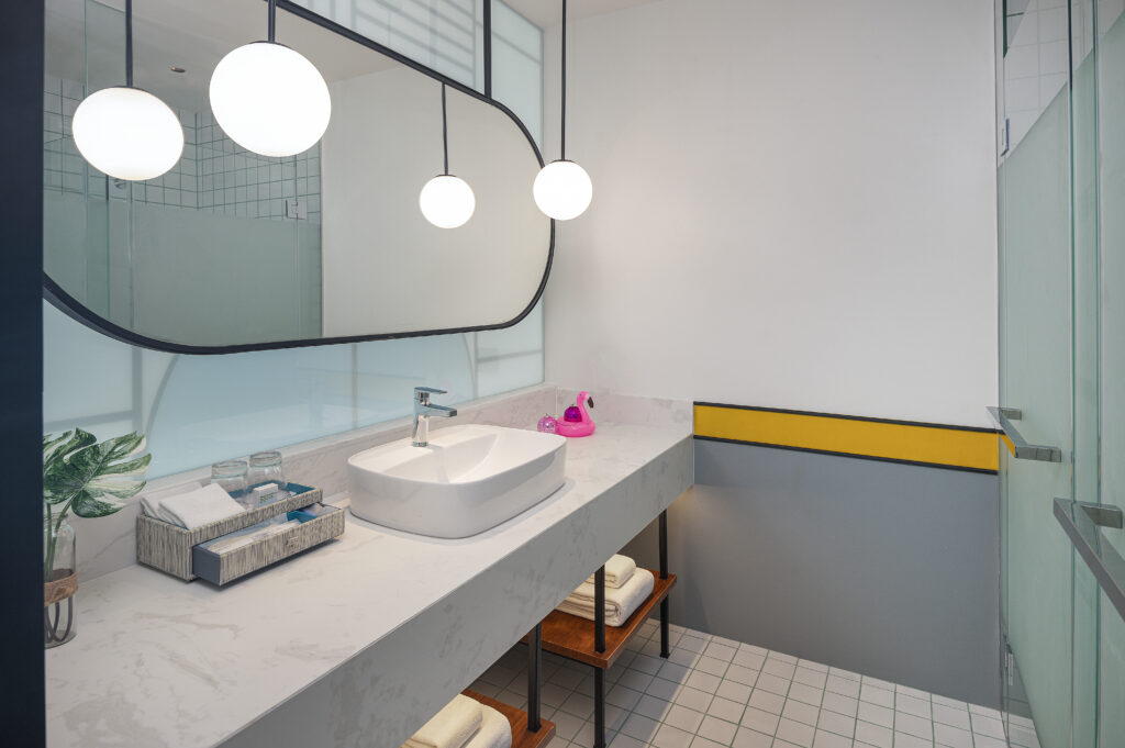 Modern bathroom with a spacious sink and mirror at Avani Chaweng Samui featuring minimalist design
