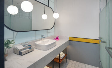 Modern bathroom with a spacious sink and mirror at Avani Chaweng Samui featuring minimalist design