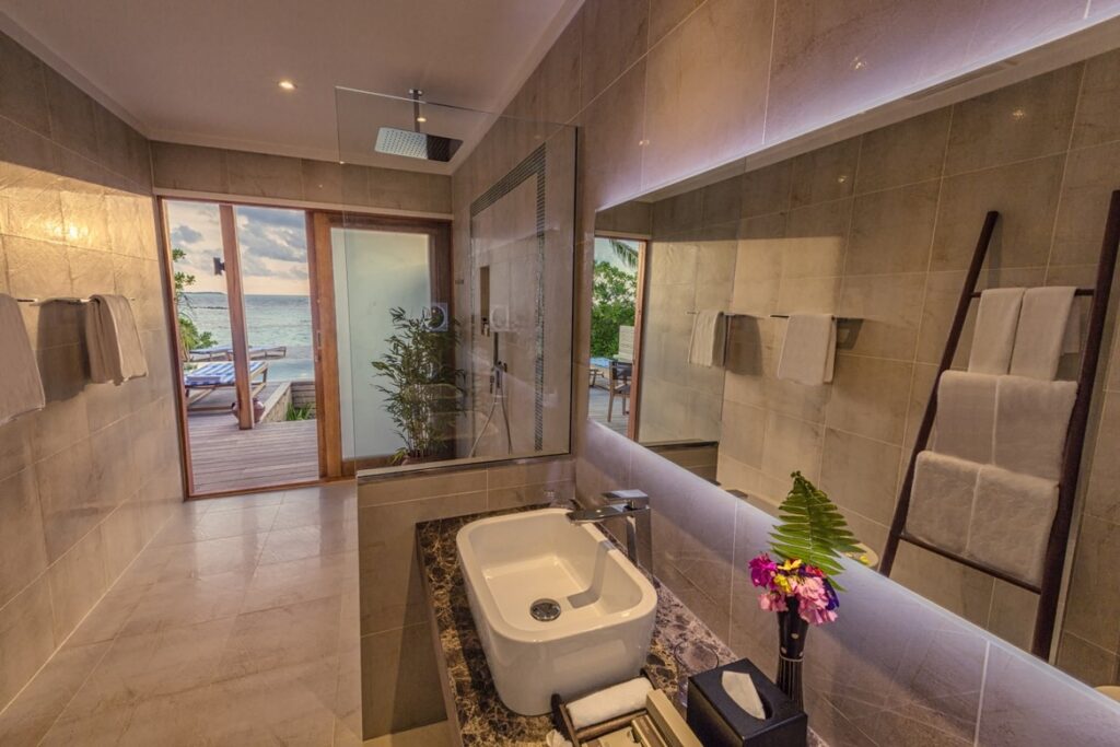 Modern bathroom with ocean view at Hurawalhi Island Resort