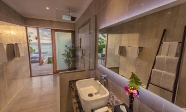 Modern bathroom with ocean view at Hurawalhi Island Resort