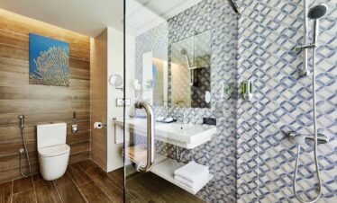 Modern bathroom with wood accents and shower at Riu Atoll
