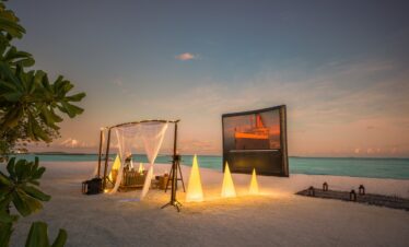 Outdoor beach movie setup at Heritance Aarah with a romantic ambiance at sunset
