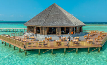 Overwater restaurant at Vilamendhoo offering dining with panoramic ocean views and fresh sea breeze