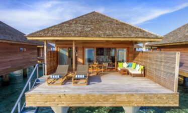 Overwater villa with a private deck and ocean access at Hurawalhi Island Resort