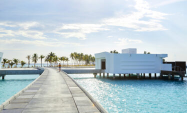 Overwater villa with white architecture at Riu Palace