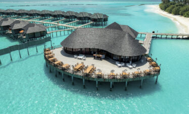Overwater villas at Sun Siyam Iru Fushi with a stunning view of the turquoise ocean surrounding the island