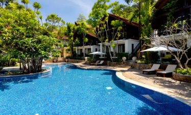 Pool area with loungers and surrounding villas at The Tubkaak Krabi resort