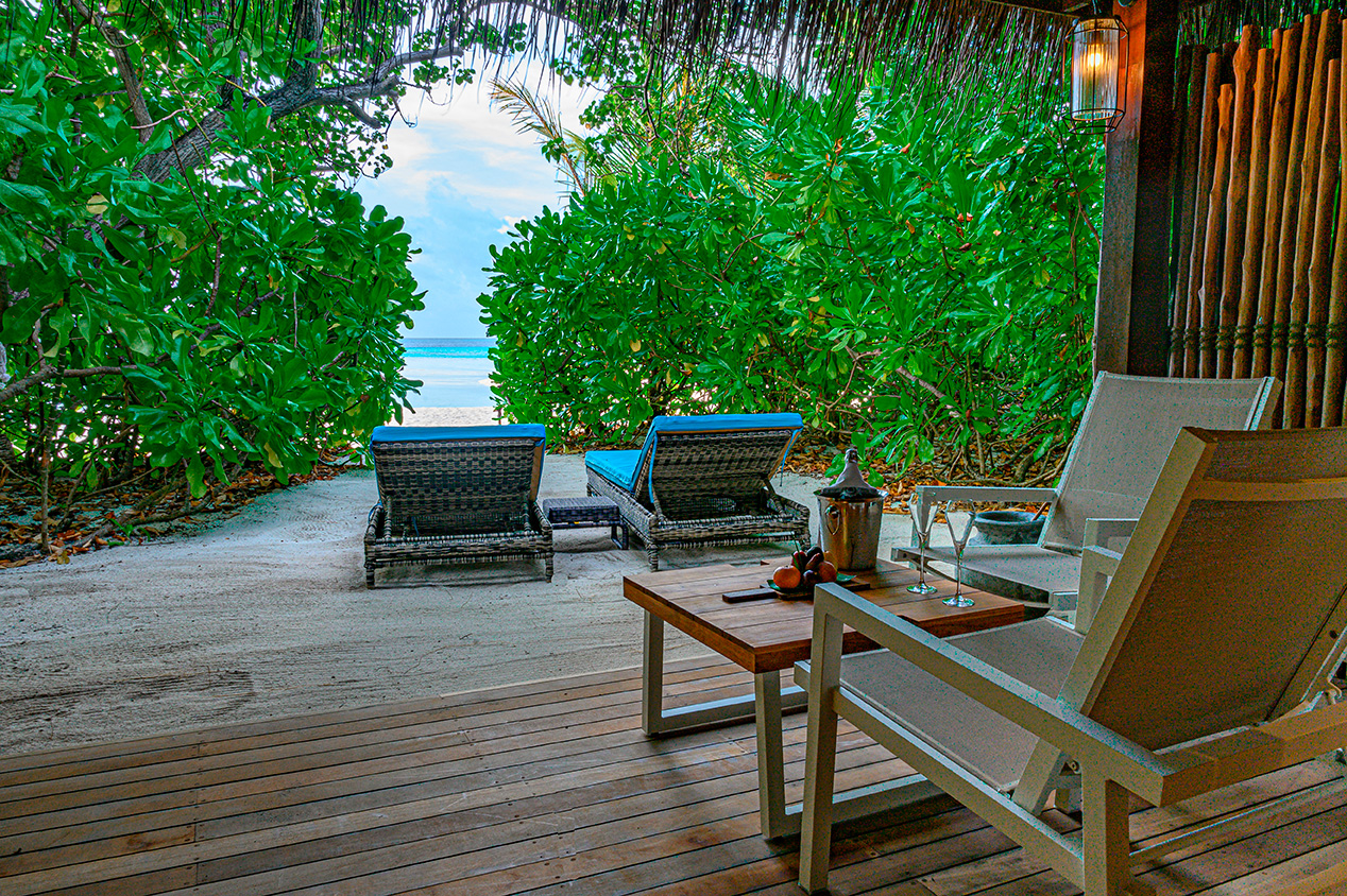 Private beachside terrace with ocean view at Constance Moofushi