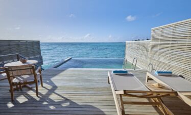 Private deck on Jawakara Dheru Island villa with infinity pool overlooking the ocean