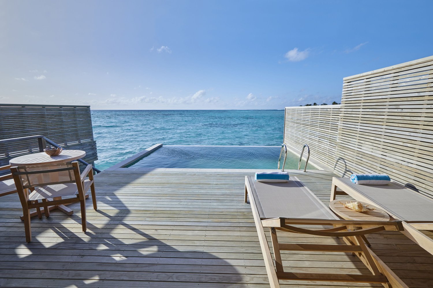 Private deck on Jawakara Dheru Island villa with infinity pool overlooking the ocean
