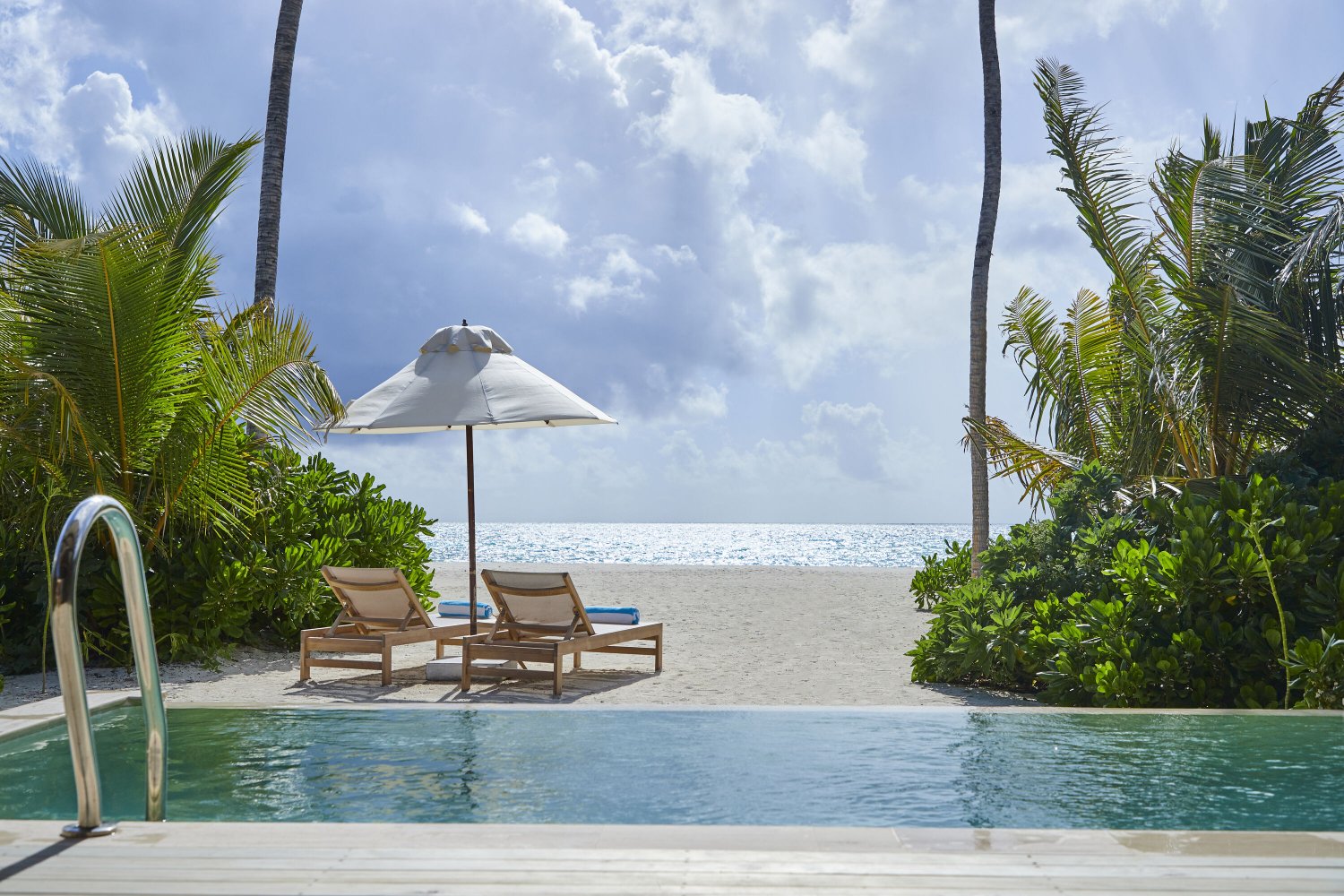 Private pool and sun loungers at Jawakara Dheru Island villa with ocean view