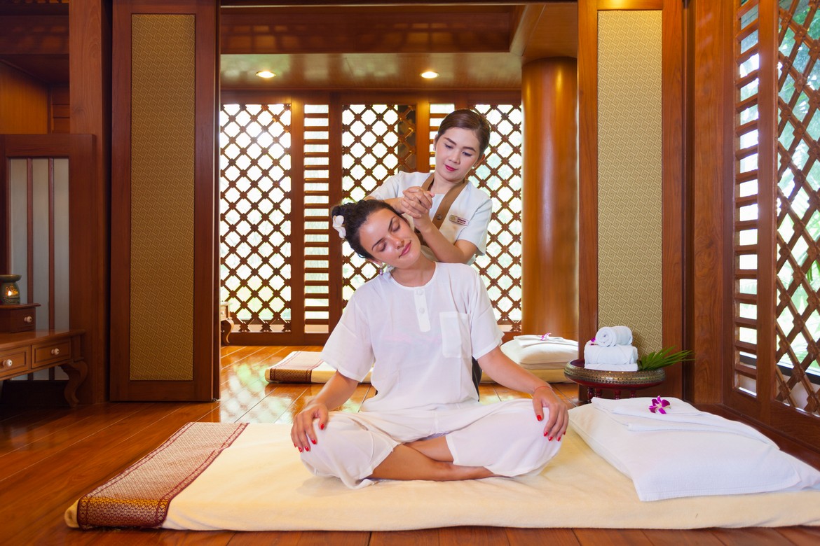 Relaxing spa session at Diamond Cliff Resort with traditional wooden decor and natural light