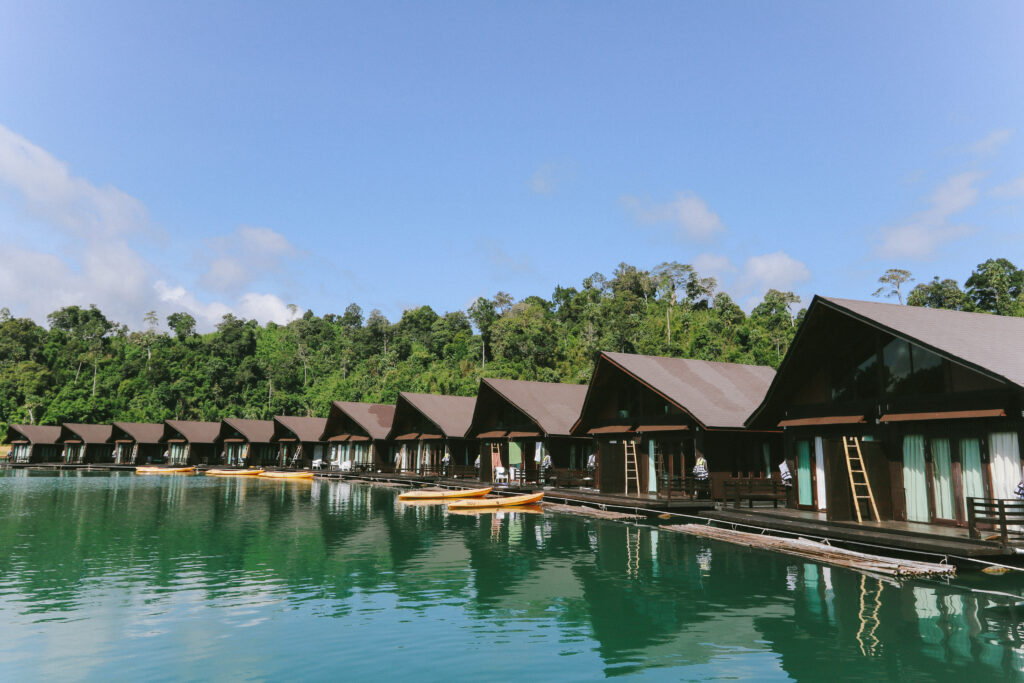 Row of floating villas reflecting on the water at 500Rai Floating Resort