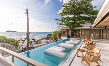 Scenic beachside pool with lounge chairs at Diamond Cliff Resort overlooking the ocean