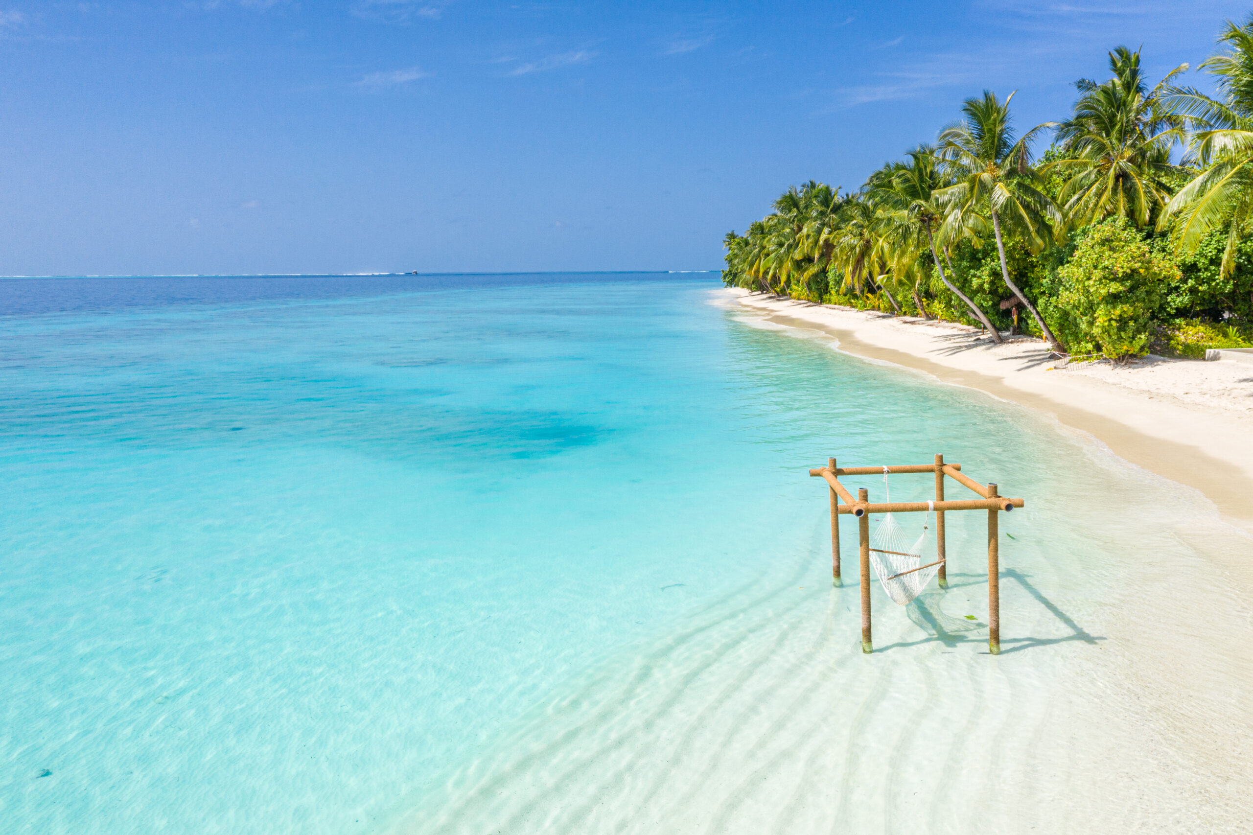 Serene beach at Ayada Maldives with a hammock floating above the clear turquoise water