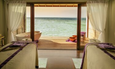 Spa room with ocean view and massage tables at Hurawalhi Island Resort