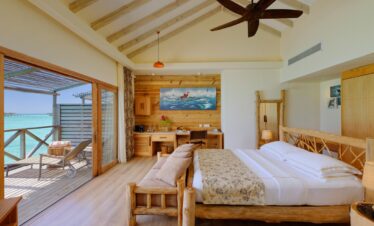 Spacious bedroom at You and Me by Cocoon overwater villa with balcony ocean view