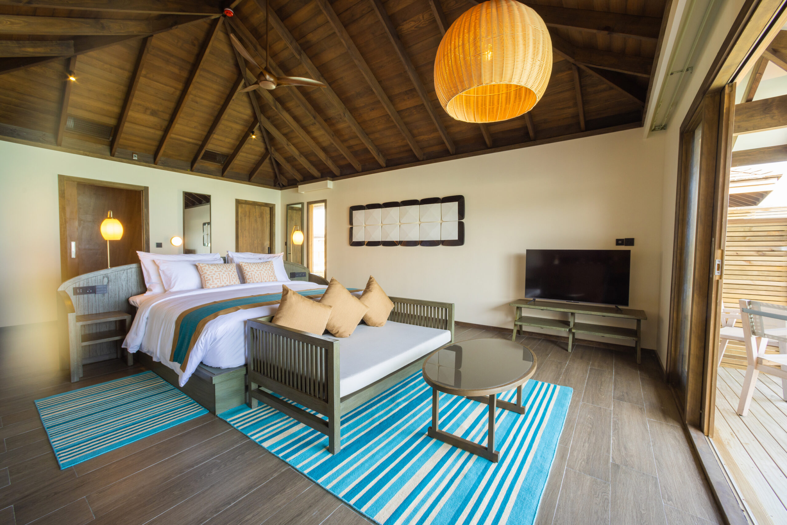 Spacious bedroom in a Jawakara Dheru Island villa with vaulted ceiling