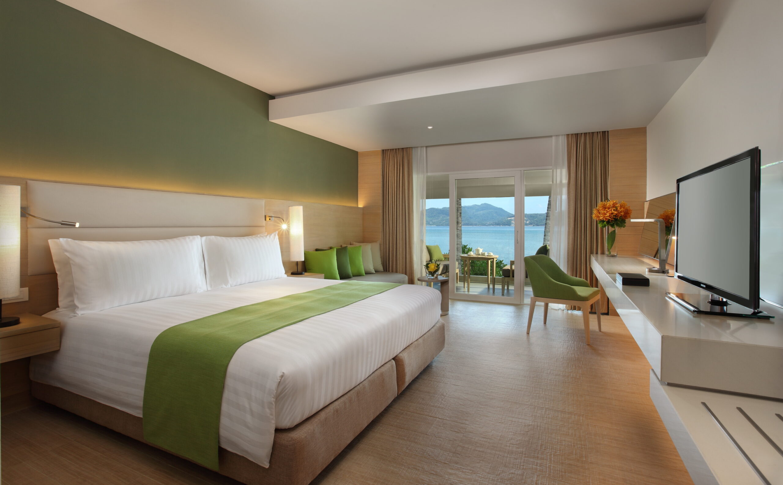 Spacious bedroom with a green theme and balcony view at Amari Phuket