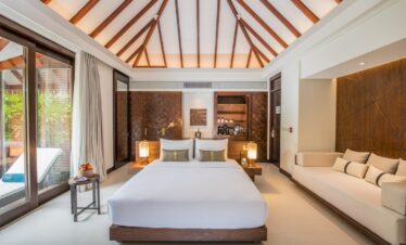 Spacious bedroom with wooden ceiling beams and modern design at Heritance Aarah