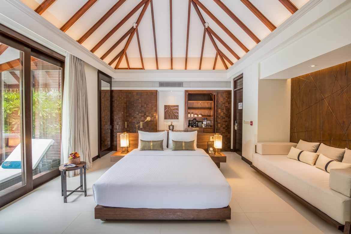 Spacious bedroom with wooden ceiling beams and modern design at Heritance Aarah
