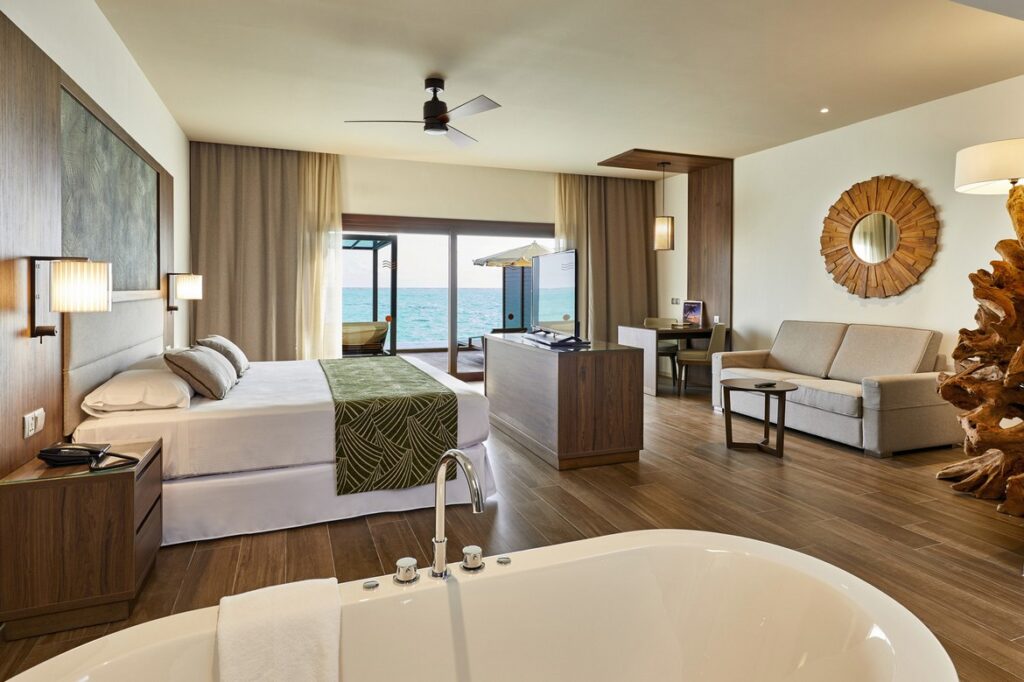 Spacious suite with ocean view and modern decor at Riu Palace